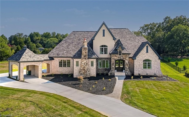 french country home with a front lawn, french doors, and a carport