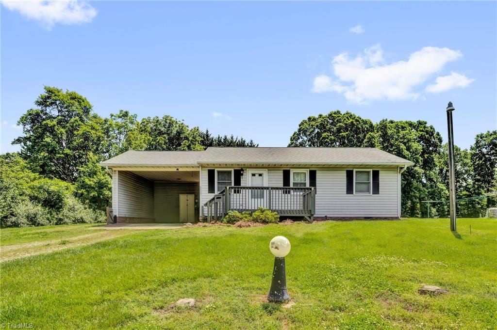 5527 NC Highway 8, Germanton, NC 27019 - ranch-style house with a front yard, a carport, and a wooden deck