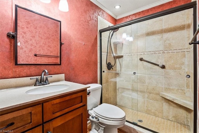 bathroom featuring vanity, toilet, a shower with door, and ornamental molding