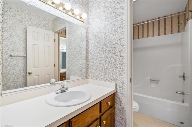 full bathroom with vanity, toilet, and washtub / shower combination