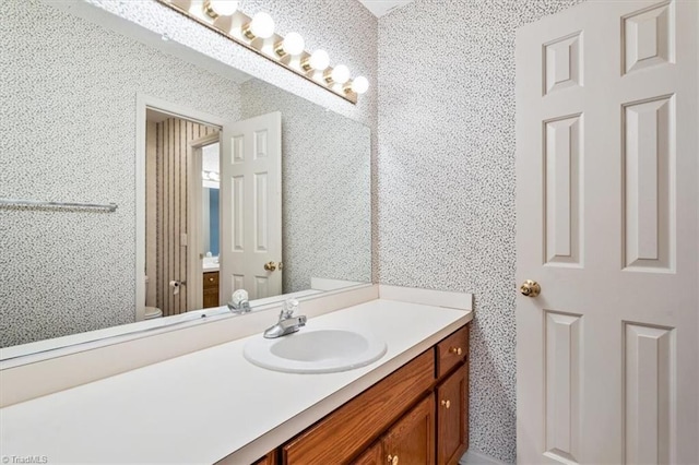 bathroom featuring vanity and toilet