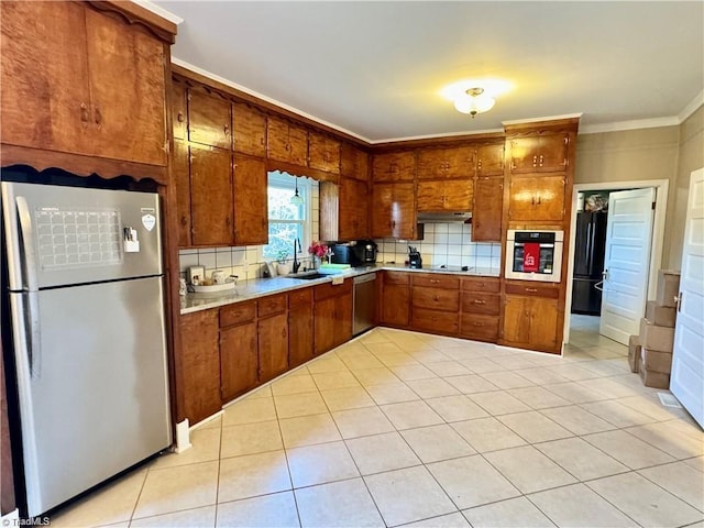 327 S Carolina Ave, Boonville, NC 27011 - kitchen with appliances with stainless steel finishes, a sink, brown cabinets, decorative backsplash, and ornamental molding