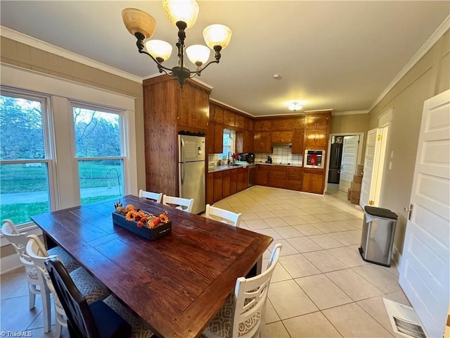 327 S Carolina Ave, Boonville, NC 27011 - dining room with light tile patterned floors, a chandelier, and ornamental molding