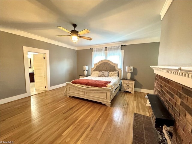 327 S Carolina Ave, Boonville, NC 27011 - bedroom with wood finished floors, baseboards, crown molding, a ceiling fan, and ensuite bath