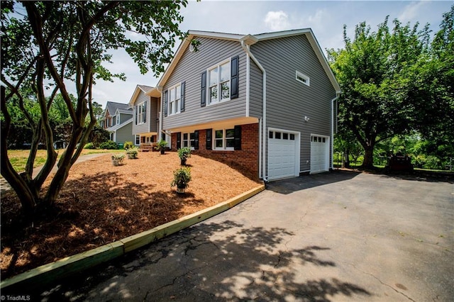 9048 Jefferson Woods Dr, King, NC 27045 - view of front of home featuring brick siding, a garage, and driveway