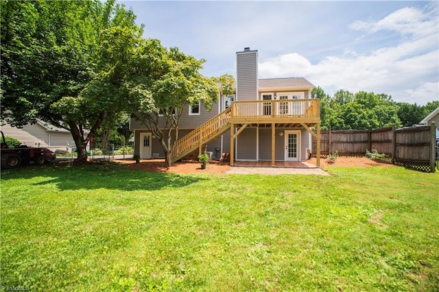 9048 Jefferson Woods Dr, King, NC 27045 - back of property with a deck, a fenced backyard, a chimney, and stairs