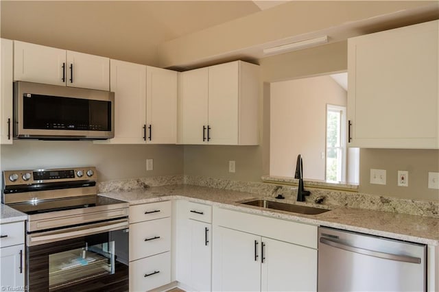 9048 Jefferson Woods Dr, King, NC 27045 - kitchen with stainless steel appliances, white cabinetry, and light stone counters