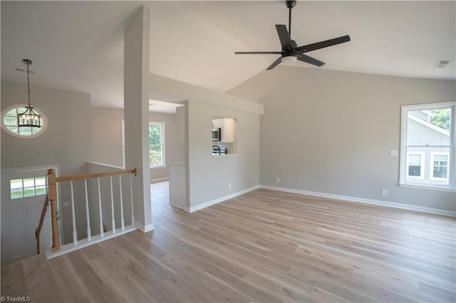 9048 Jefferson Woods Dr, King, NC 27045 - unfurnished room with light wood finished floors, a ceiling fan, a chandelier, and high vaulted ceiling