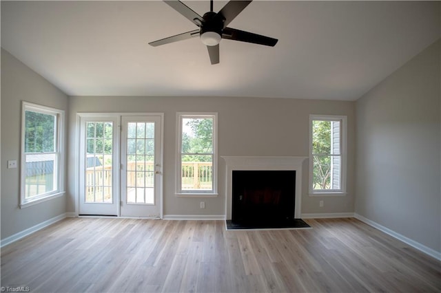 9048 Jefferson Woods Dr, King, NC 27045 - unfurnished living room featuring vaulted ceiling, light wood finished floors, a ceiling fan, and a fireplace with flush hearth