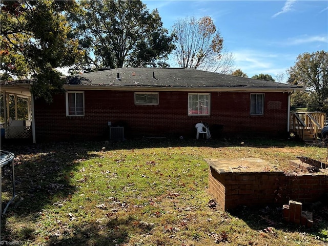 view of home's exterior featuring cooling unit and a lawn