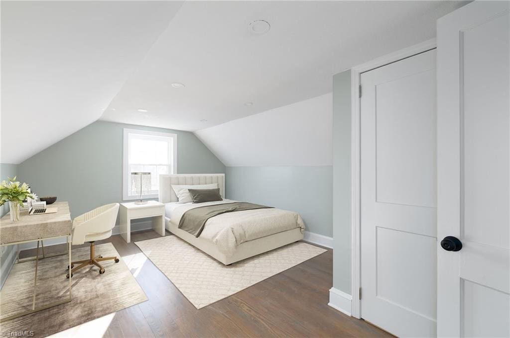 bedroom featuring dark hardwood / wood-style flooring and vaulted ceiling