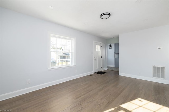 unfurnished room with hardwood / wood-style floors