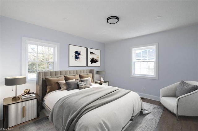 bedroom with multiple windows and dark wood-type flooring