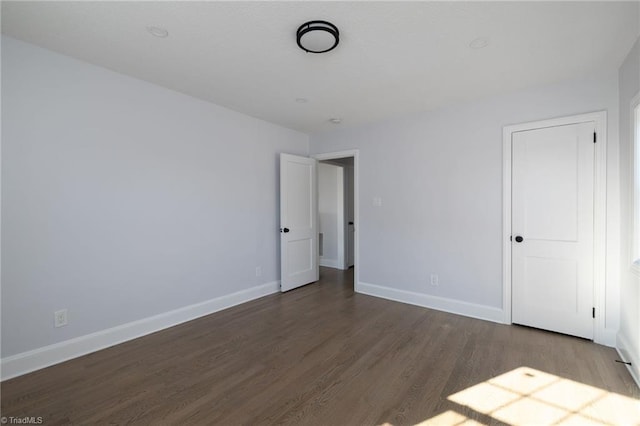 unfurnished bedroom featuring dark wood-type flooring