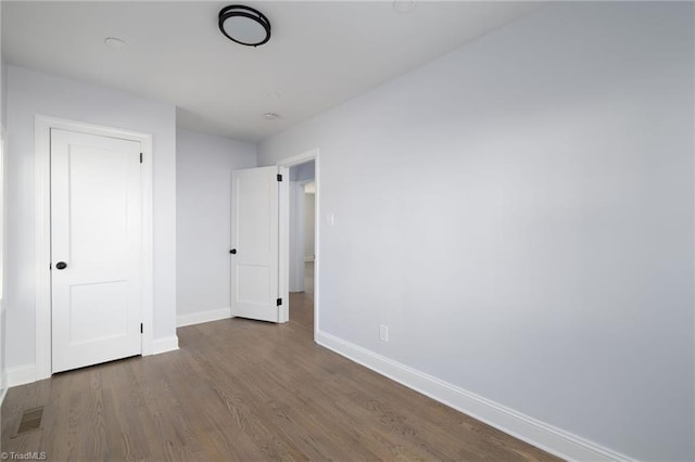 unfurnished bedroom with wood-type flooring