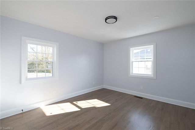 spare room with dark hardwood / wood-style floors