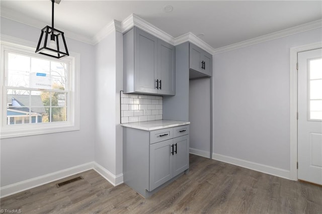 kitchen with gray cabinetry, plenty of natural light, and tasteful backsplash