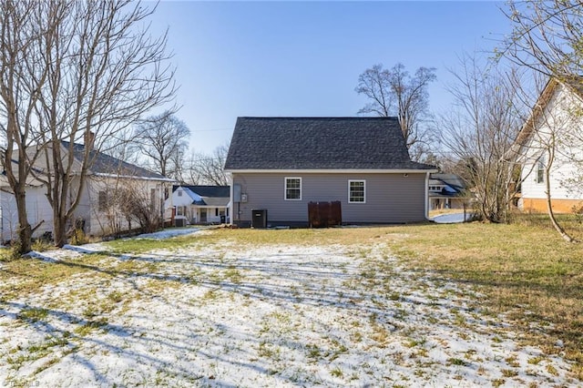 snow covered rear of property with central AC unit