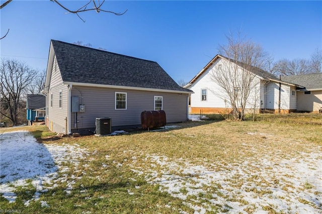 rear view of property with a yard and central AC unit