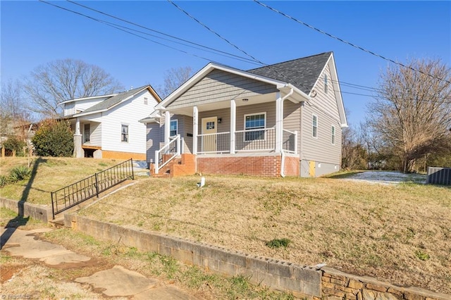 bungalow featuring a porch, cooling unit, and a front lawn