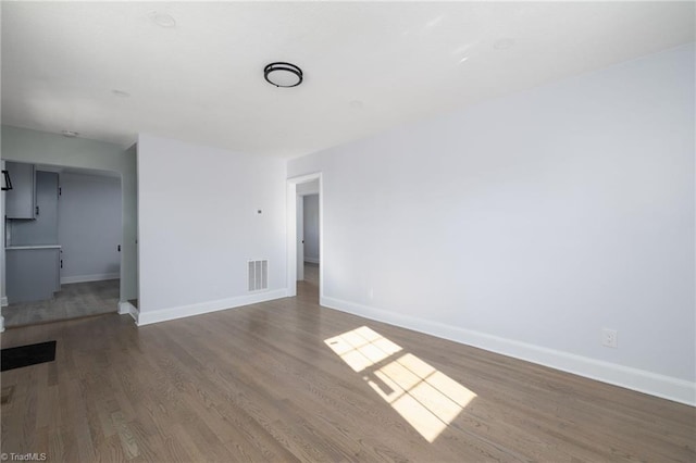 unfurnished room with wood-type flooring