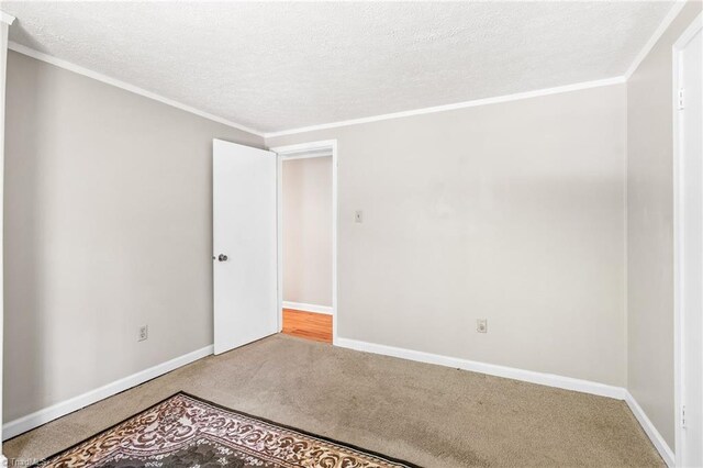 1765 K Fork Rd, Madison, NC 27025 - spare room featuring carpet floors, baseboards, a textured ceiling, and ornamental molding