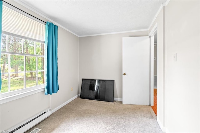 1765 K Fork Rd, Madison, NC 27025 - spare room with a baseboard radiator, carpet floors, crown molding, baseboards, and a textured ceiling
