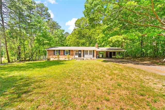 1765 K Fork Rd, Madison, NC 27025 - single story home with a chimney, a front yard, driveway, a carport, and brick siding