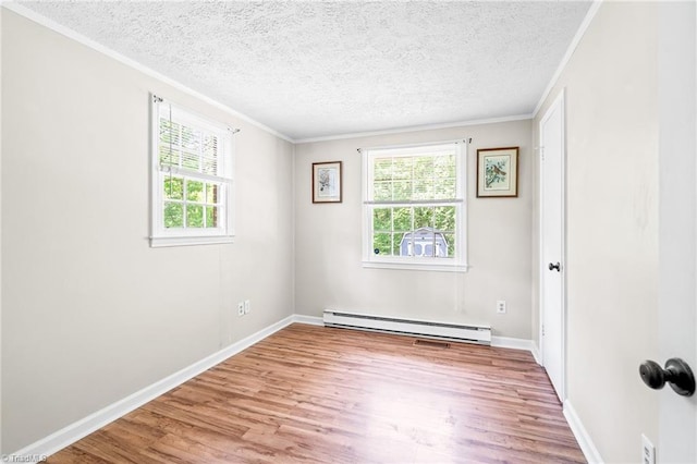 1765 K Fork Rd, Madison, NC 27025 - empty room with a baseboard heating unit, healthy amount of natural light, light wood finished floors, a textured ceiling, and ornamental molding