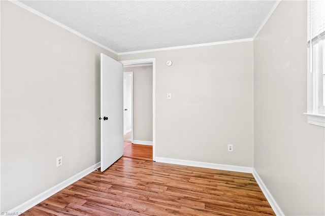 1765 K Fork Rd, Madison, NC 27025 - spare room with wood finished floors, a textured ceiling, baseboards, and ornamental molding