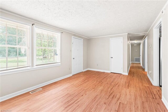 1765 K Fork Rd, Madison, NC 27025 - unfurnished bedroom with light wood-type flooring, baseboards, and a textured ceiling