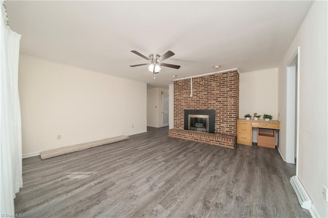 unfurnished living room with ceiling fan, a fireplace, crown molding, and dark hardwood / wood-style floors