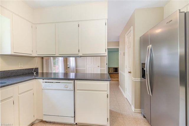 1601 Heraldry Ln, Greensboro, NC 27455 - kitchen featuring stainless steel fridge, white dishwasher, dark countertops, and a peninsula