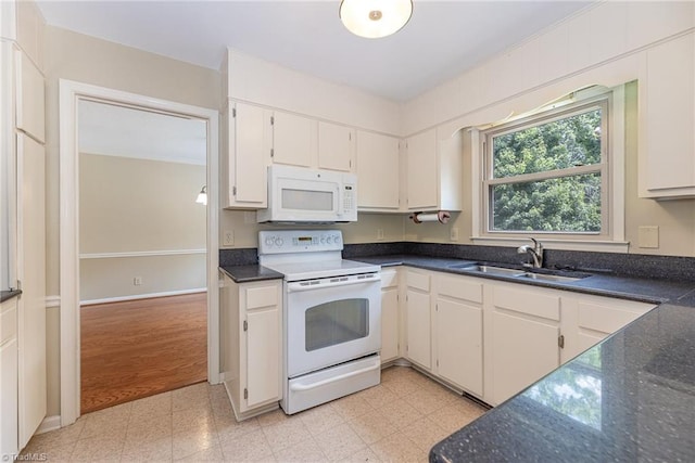 1601 Heraldry Ln, Greensboro, NC 27455 - kitchen featuring white appliances, light floors, and dark stone counters