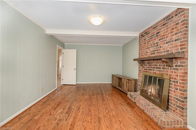 1601 Heraldry Ln, Greensboro, NC 27455 - unfurnished living room featuring crown molding, a fireplace, wood finished floors, and wood walls