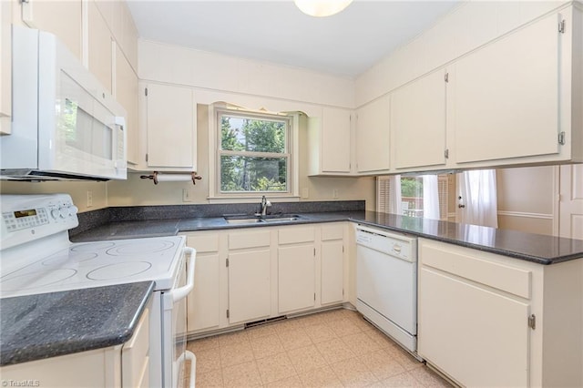 1601 Heraldry Ln, Greensboro, NC 27455 - kitchen featuring white appliances, plenty of natural light, and dark countertops