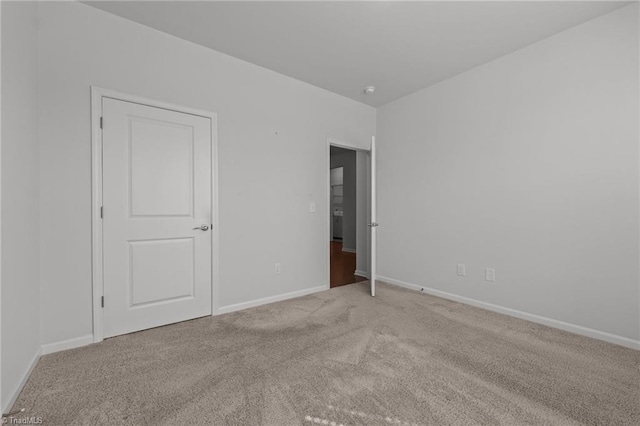 unfurnished bedroom with baseboards and carpet floors