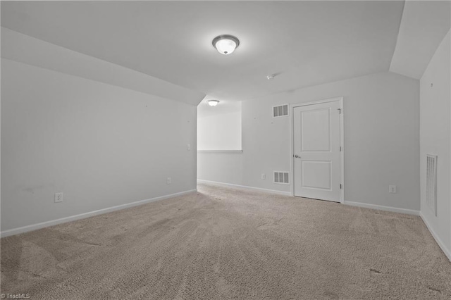 unfurnished room featuring baseboards, visible vents, and carpet floors