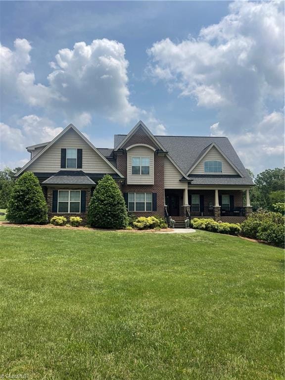 375 Pebblestone Ct, Lexington, NC 27295 - view of front of house with brick siding, covered porch, and a front lawn