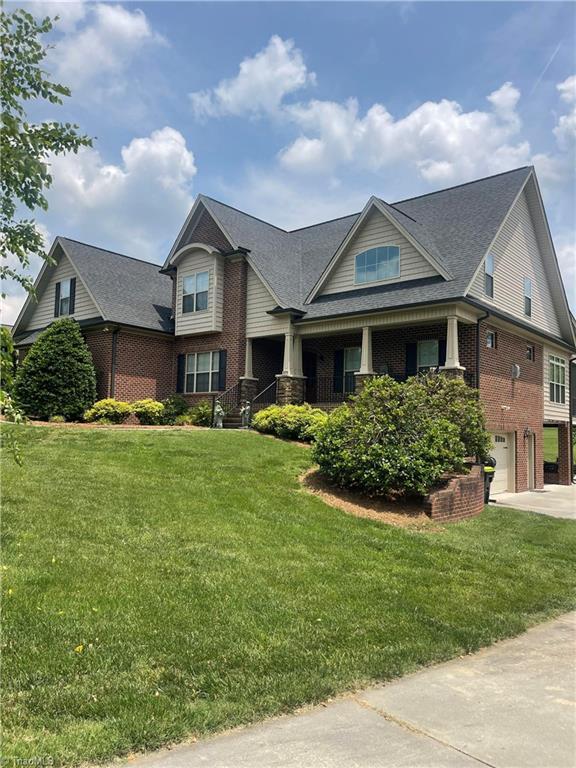375 Pebblestone Ct, Lexington, NC 27295 - craftsman inspired home featuring brick siding, a garage, driveway, and a front lawn