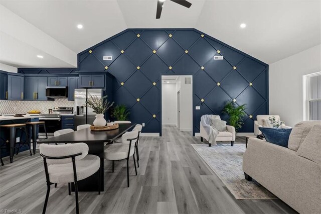 7126 Whitetail Dr, Julian, NC 27283 - dining room with light wood-style flooring, an accent wall, a ceiling fan, recessed lighting, and lofted ceiling