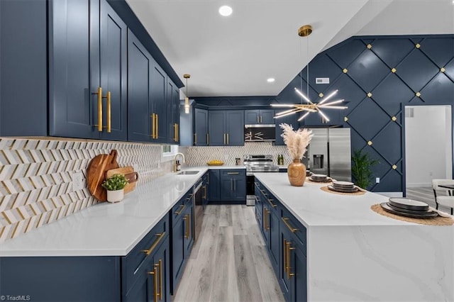 7126 Whitetail Dr, Julian, NC 27283 - kitchen featuring backsplash, blue cabinets, appliances with stainless steel finishes, a sink, and light wood-style flooring