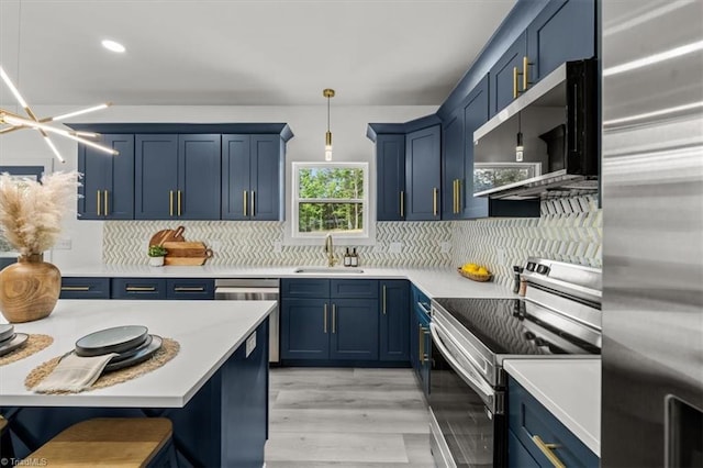 7126 Whitetail Dr, Julian, NC 27283 - kitchen with appliances with stainless steel finishes, a sink, light countertops, decorative light fixtures, and blue cabinets