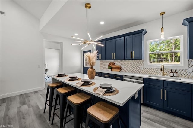 7126 Whitetail Dr, Julian, NC 27283 - kitchen with a kitchen breakfast bar, light countertops, a sink, backsplash, and blue cabinetry