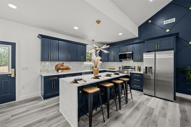 7126 Whitetail Dr, Julian, NC 27283 - kitchen with visible vents, blue cabinets, appliances with stainless steel finishes, and light countertops