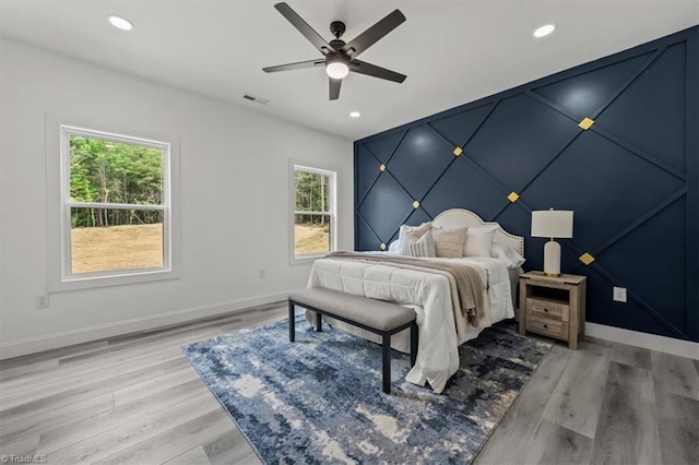 7126 Whitetail Dr, Julian, NC 27283 - bedroom with baseboards, light wood-style flooring, and multiple windows