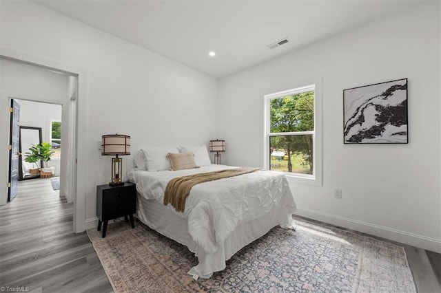 7126 Whitetail Dr, Julian, NC 27283 - bedroom with baseboards, recessed lighting, wood finished floors, and visible vents
