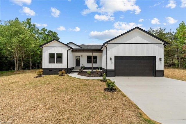 7126 Whitetail Dr, Julian, NC 27283 - modern farmhouse style home featuring an attached garage, driveway, and a front yard