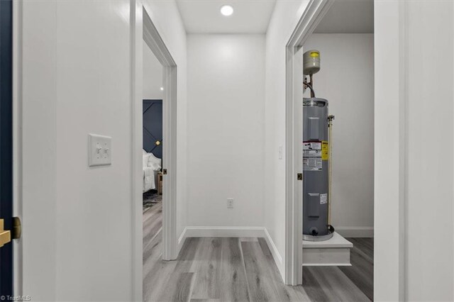 7126 Whitetail Dr, Julian, NC 27283 - hallway featuring baseboards, water heater, and wood finished floors