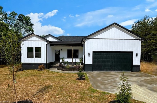 7126 Whitetail Dr, Julian, NC 27283 - view of front of house with a porch, a garage, a front lawn, and concrete driveway